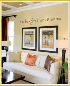 language wall lettering above two large pictures in living room