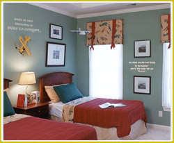 kid's room wall decal above bedside lamp and between wall photos in kid's flying room