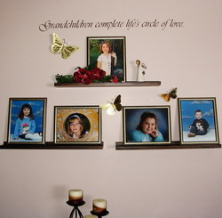 GrandChildren Complete Life's Circle of Love - Wall quotation on top of children's pictures on the shelves attached to a lavender wall.