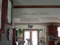Home Sweet Home wall quotes with a fancy end lettering art on the wooden beam in the kitchen area.