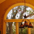An inspirational wall quotation right above the colonial design window with an over-hang 3 piece chandelier