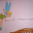Cutie Pie and her Dream beside Tinkerbell with her magical wand on the center of a lavender wall with a baby crib in the baby's room.