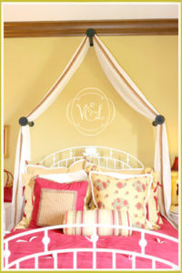 kid's room wall monogram decal below curtain canopy in girl's room