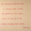 A romantic Italian wall quote on a pastel colored wall.