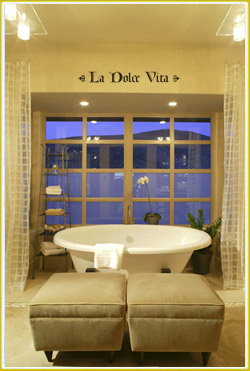 inspirational wall lettering above large glass paneled window in Italian bathroom