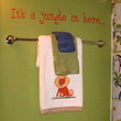 Jungle-themed wall decal above the towel holder in children's bathroom - Its a jungle in here.