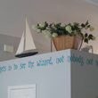 Nobody gets in to see the wizard, Not nobody not no how!A wall lettering on the overhead partition with a sailboat and flowers as accessories.