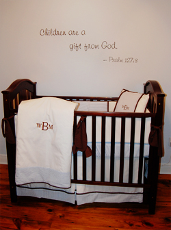 A bible verse wall inscriptions on the center with a wooden baby's crib in the baby's room