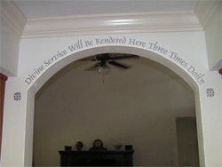 A wall decal with decorative ends on the archway right below the ceiling moulding - Divine service will be rendered here three times daily