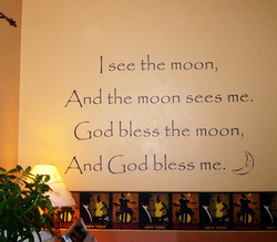 I see the moon, and the moon sees me. God bless the moon and god bless me, a wall decal above the wallpaper design in the bedroom with a lampshade on the side