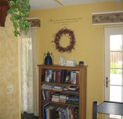 A wall decal above the bookshelves and in-between the door and window with 2 curtain boxes accessories