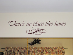 There's no place like home a wall decal with ornamental embellishment above the window curtain