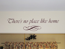 There's no place like home a wall decal with ornamental embellishment above the window curtain