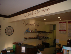 Eat, Drink, and be merry - wall decal on the overhead beam in the cafe area.