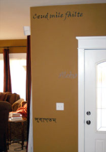 Wall lettering beside the main entrance door and a sofa at the left side of the area