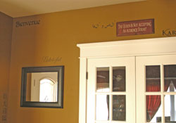 Welcome Words in every part of the wall with a colonial design glass panel door. - Welcomes from around the world.
