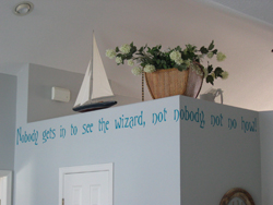 Nobody gets in to see the wizard, Not nobody not no how!A wall lettering on the overhead partition with a sailboat and flowers as accessories.